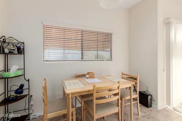 a dining room with furniture and window