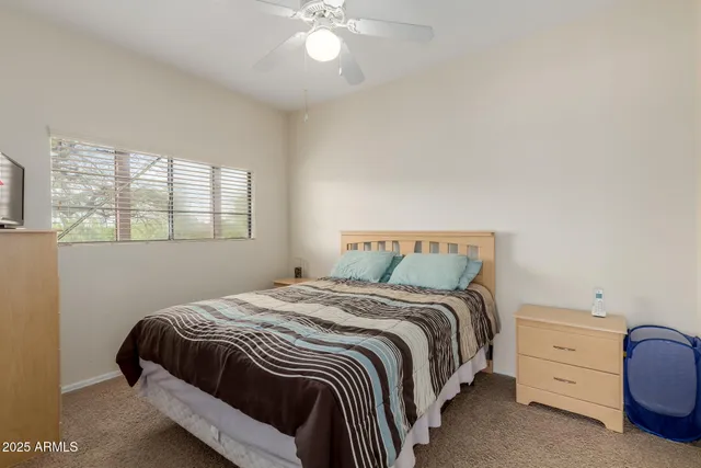 a bedroom with a bed and window