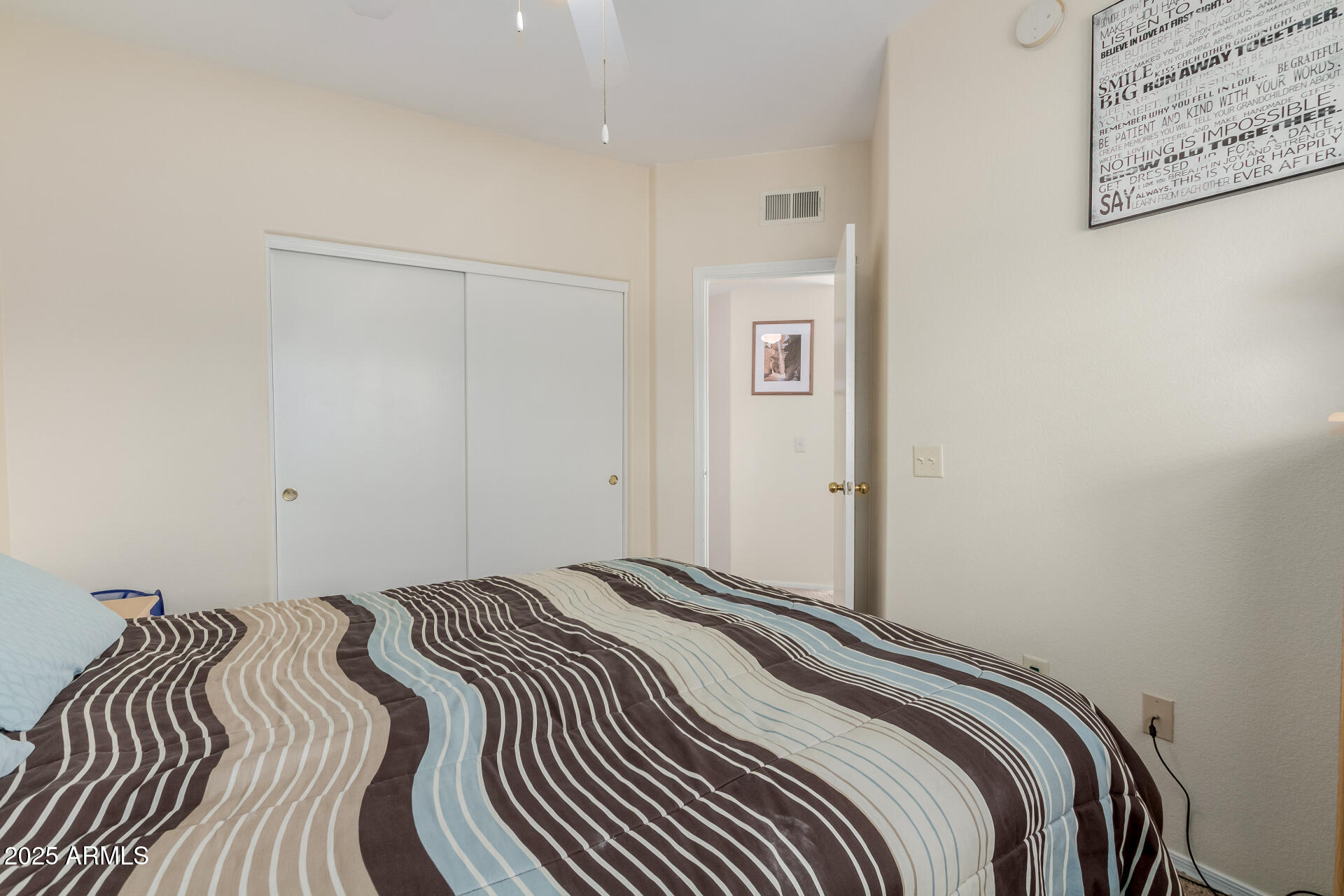 3434 East Baseline Road, Unit 246 Phoenix, AZ 85042 - Photo 21 of 43 a bedroom with a bed and a painting on the wall