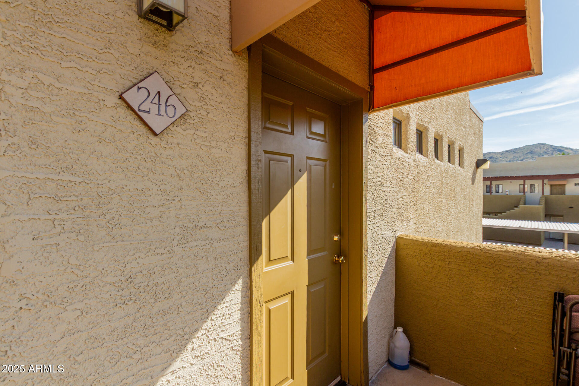 3434 East Baseline Road, Unit 246 Phoenix, AZ 85042 - Photo 7 of 43 a view of a door and chair in the balcony
