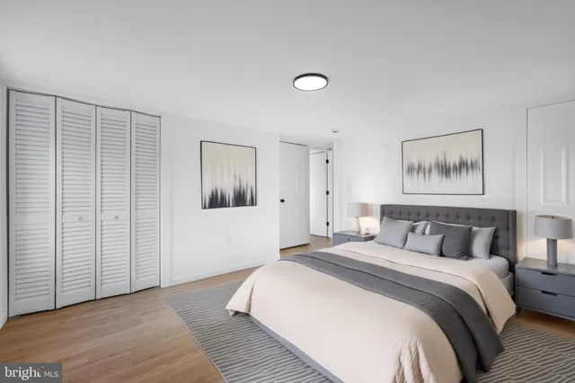 a bedroom with a large bed and a chandelier