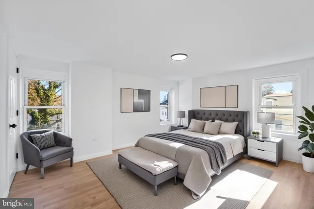 a bedroom with a bed and a couch