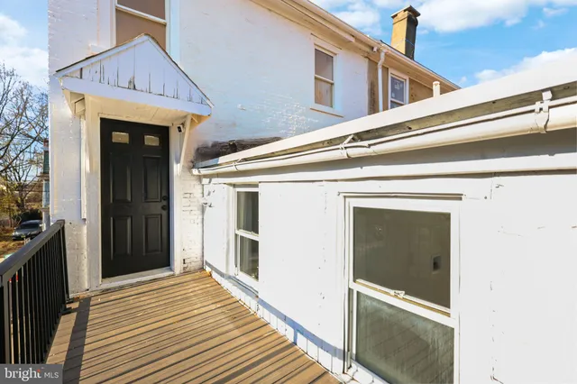 a view of a house with wooden deck