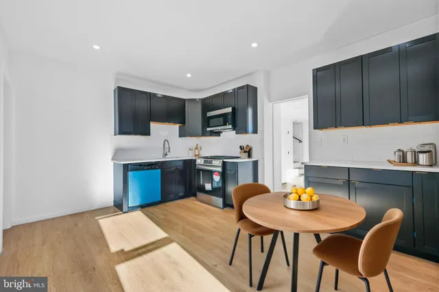 a kitchen with a table chairs and a refrigerator