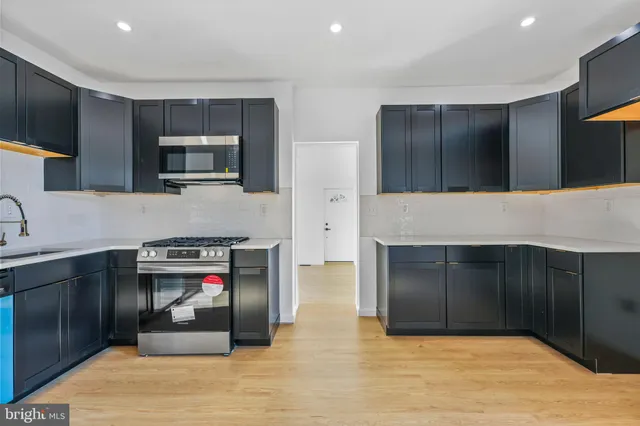 a kitchen with stainless steel appliances granite countertop a stove and a refrigerator