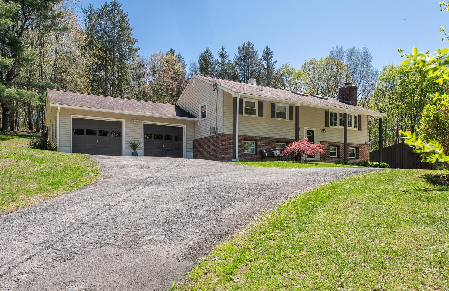 a front view of house with yard and green space