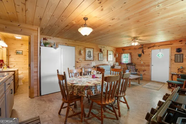 a view of a dining room with furniture and a chandelier
