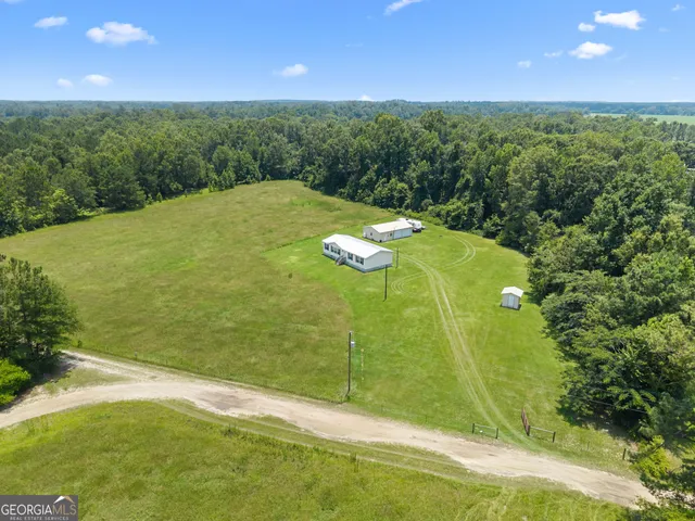 a view of a big yard with table and chairs