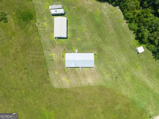 a view of a house with a yard and sitting area
