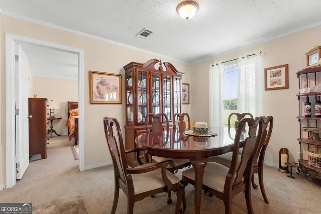 a view of a dining room with furniture and window