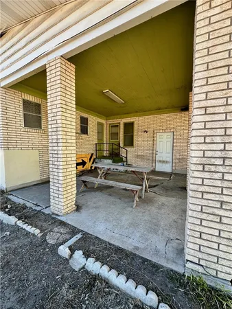 a backyard of a house with barbeque oven table and chairs