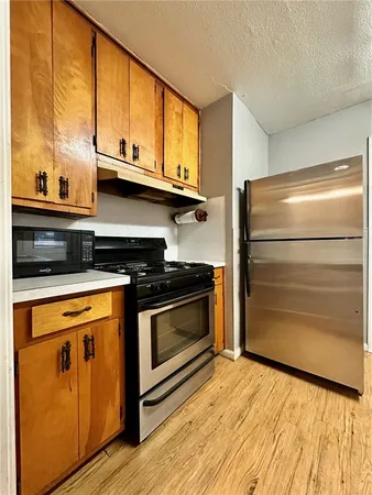 a kitchen with stainless steel appliances granite countertop a stove and a microwave