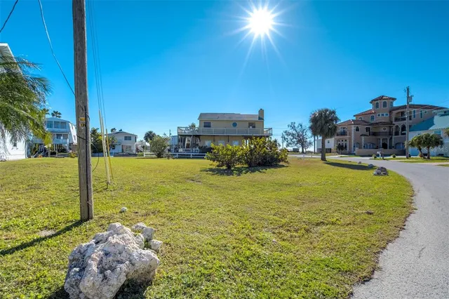 a swimming pool with outdoor seating and yard