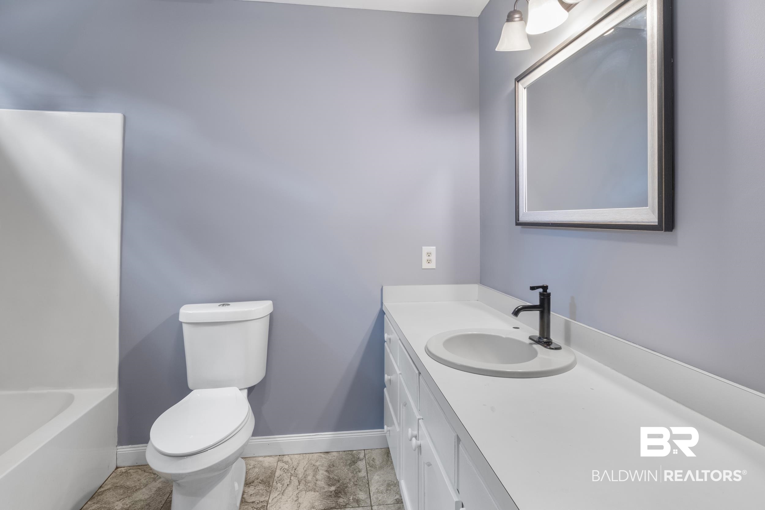 150 Montclair Loop Daphne, AL 36526 - Photo 22 of 29 Bathroom with tile floors, vanity with extensive cabinet space, and toilet