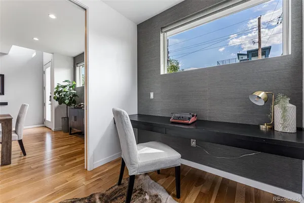 a workspace with furniture and wooden floor