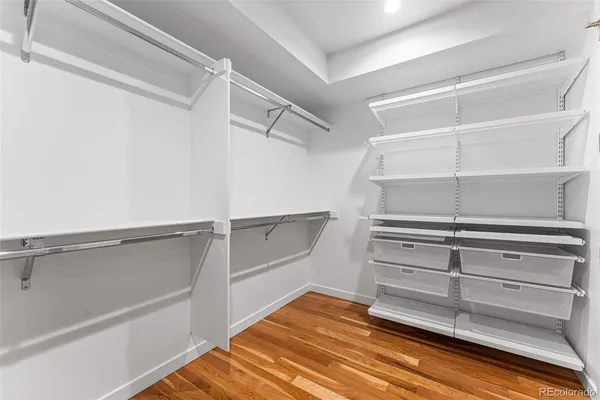 a view of walk in closet with empty racks