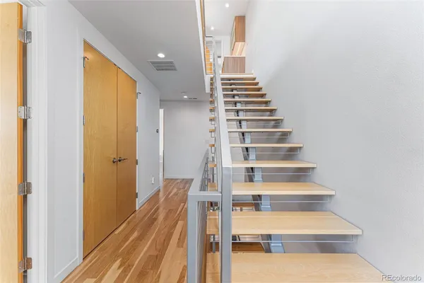 a view of entryway and hall with wooden floor
