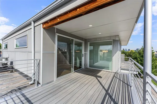 a front view of a house with plants and a tree