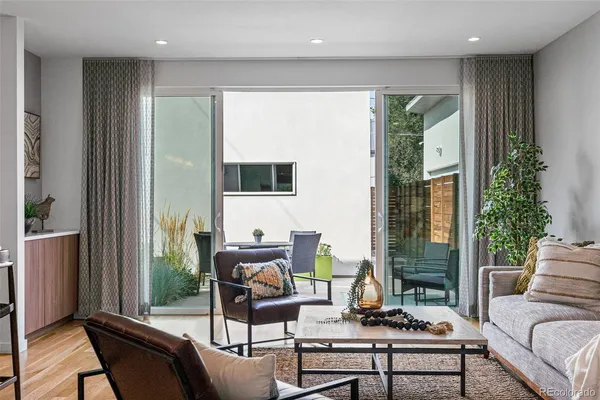 a living room with furniture and a potted plant