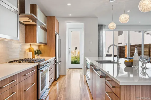 a kitchen with stainless steel appliances granite countertop a stove and a sink