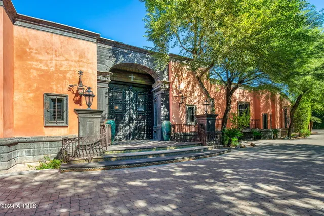 a view of an empty room with fireplace and fan