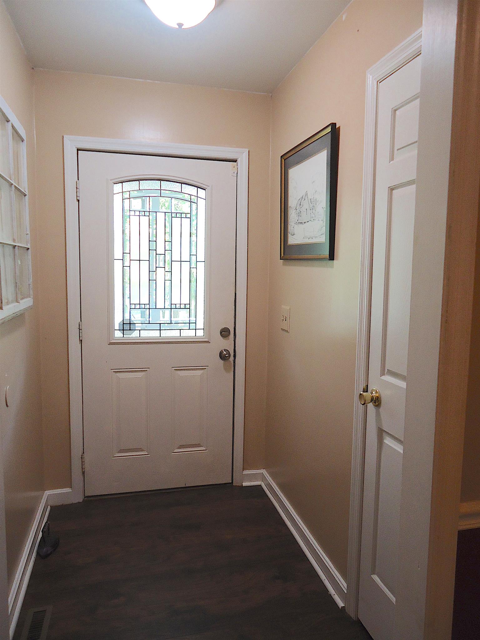 4481 Washington Road Greenbrier, TN 37073 - Photo 3 of 30 an empty room with wooden floor and windows