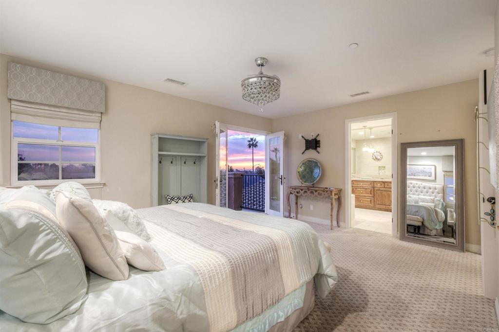 917 Santo Way Cardiff-by-the-Sea, CA 92007 - Photo 15 of 43 a bedroom with a large bed and a large window