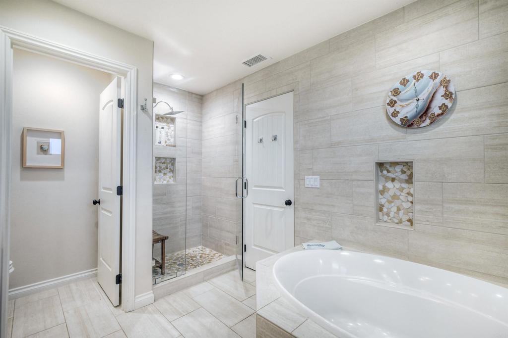 917 Santo Way Cardiff-by-the-Sea, CA 92007 - Photo 19 of 43 a bathroom with a bathtub and shower