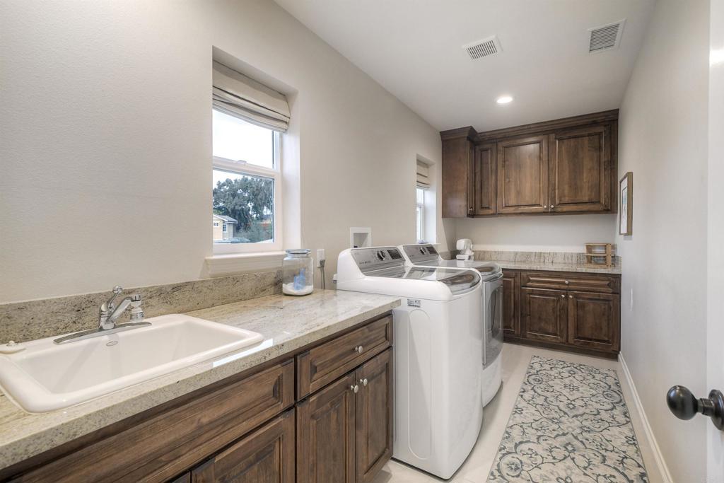 917 Santo Way Cardiff-by-the-Sea, CA 92007 - Photo 26 of 43 a kitchen with a sink stove and cabinets