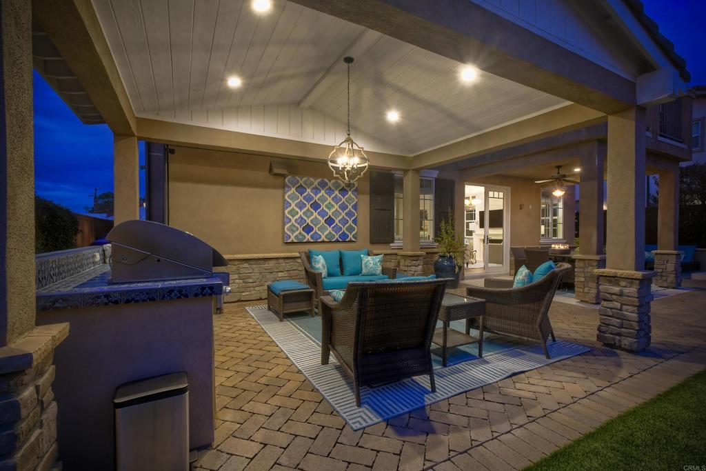 917 Santo Way Cardiff-by-the-Sea, CA 92007 - Photo 35 of 43 a living room with furniture a flat screen tv and a dining table