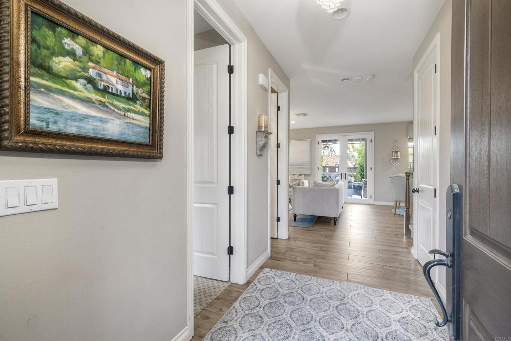 917 Santo Way Cardiff-by-the-Sea, CA 92007 - Photo 4 of 43 a view of a hallway with wooden floor and furniture