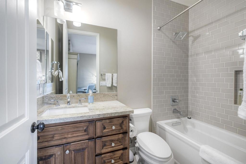 917 Santo Way Cardiff-by-the-Sea, CA 92007 - Photo 6 of 43 a bathroom with a sink vanity mirror toilet and bathtub