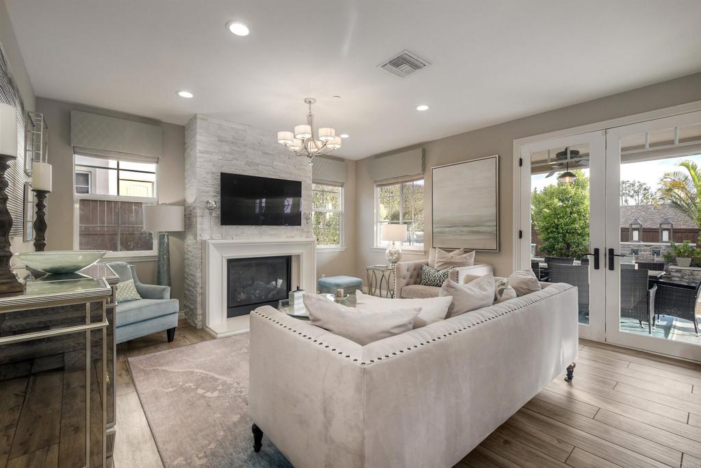 917 Santo Way Cardiff-by-the-Sea, CA 92007 - Photo 7 of 43 a living room with furniture a fireplace and a floor to ceiling window