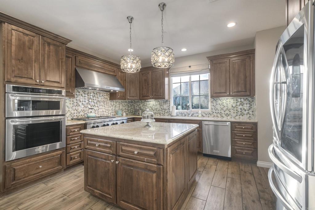 917 Santo Way Cardiff-by-the-Sea, CA 92007 - Photo 8 of 43 a kitchen with stainless steel appliances granite countertop a sink stove and refrigerator