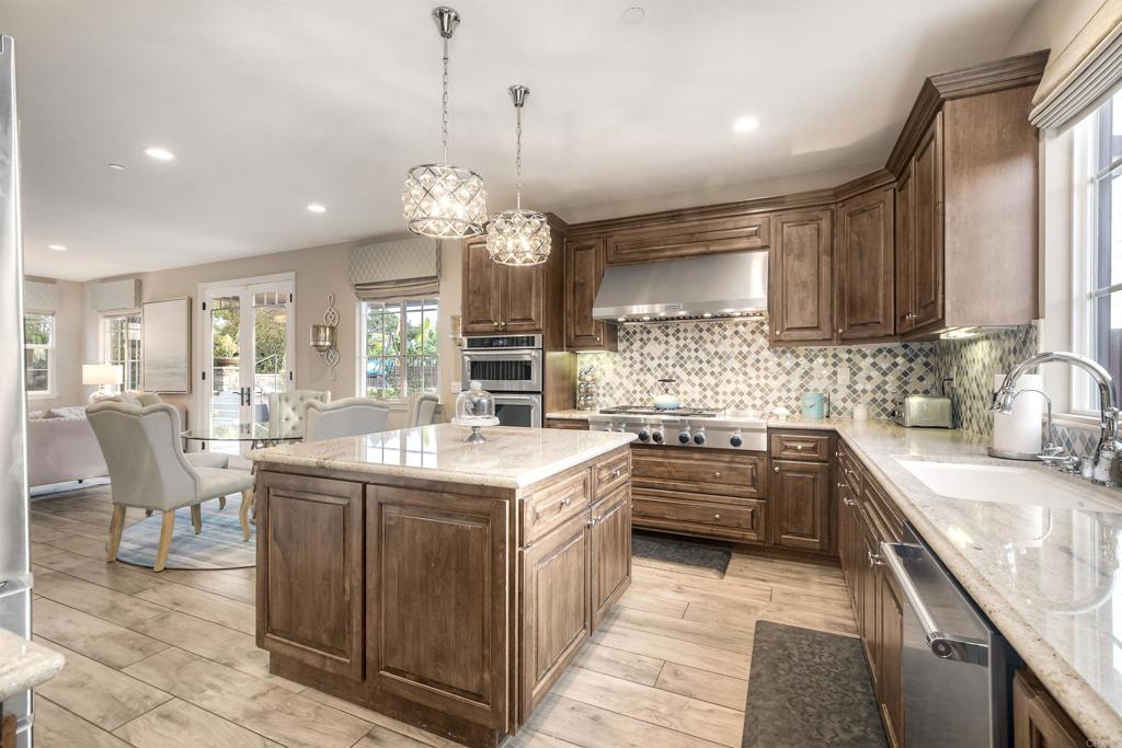 917 Santo Way Cardiff-by-the-Sea, CA 92007 - Photo 9 of 43 a kitchen with a sink stove and cabinets