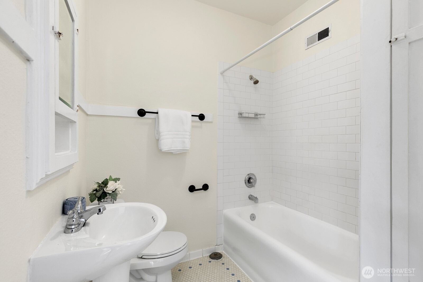 901 Northeast 43rd Street, Unit 306 Seattle, WA 98105 - Photo 15 of 23 a white bath tub sitting next to a white toilet and sink