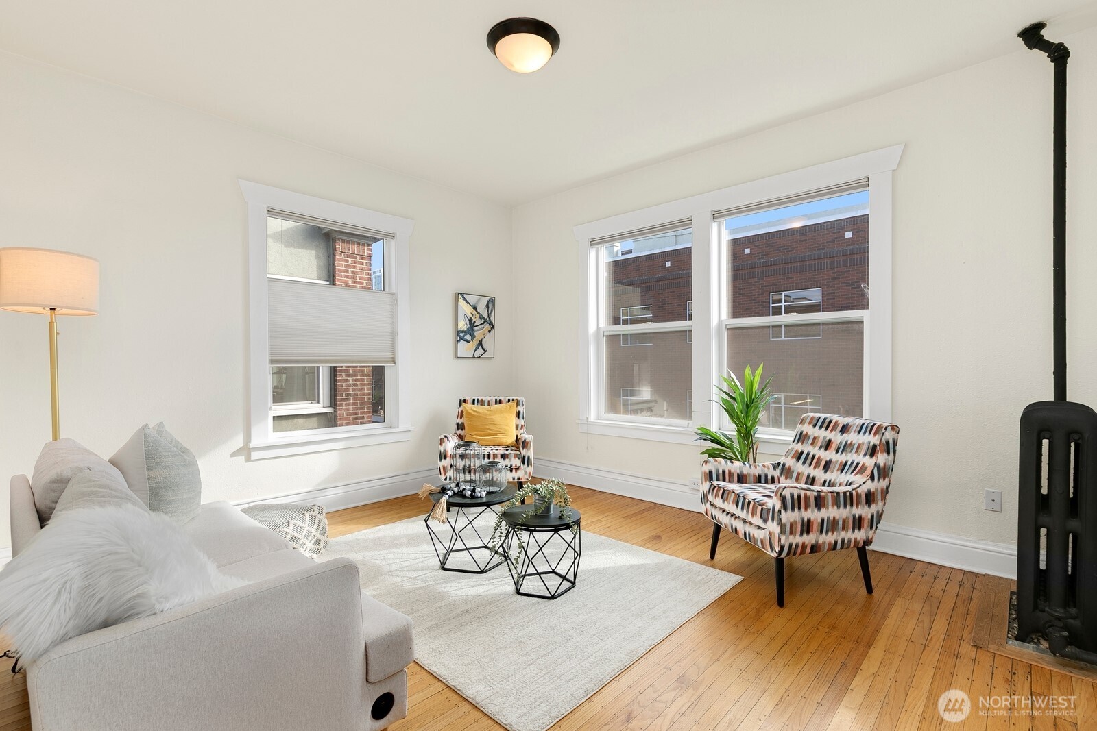 901 Northeast 43rd Street, Unit 306 Seattle, WA 98105 - Photo 3 of 23 a living room with furniture and a table