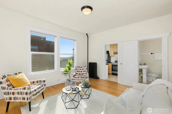 a living room with furniture and wooden floor