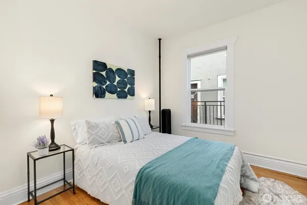 a bedroom with a bed and a lamp