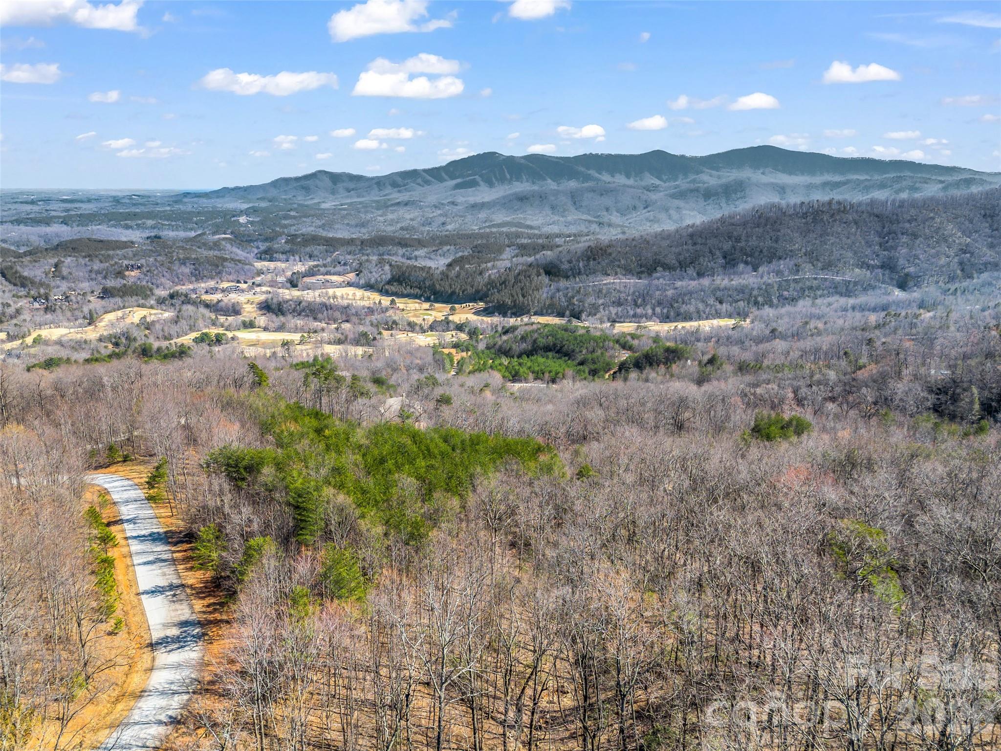 190 Cherry Hill, Unit NONE Mill Spring, NC 28756 - Photo 27 of 39 a view of a lake with mountains in the background