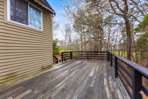 a view of balcony with wooden floor and fence