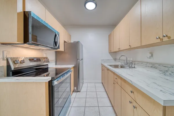 a kitchen with a sink stove and cabinets