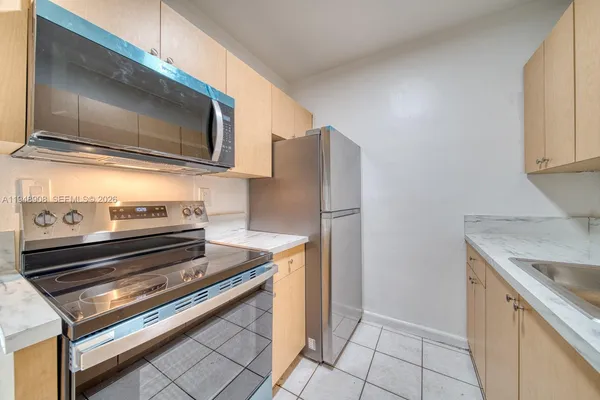 a kitchen with a refrigerator stove and microwave