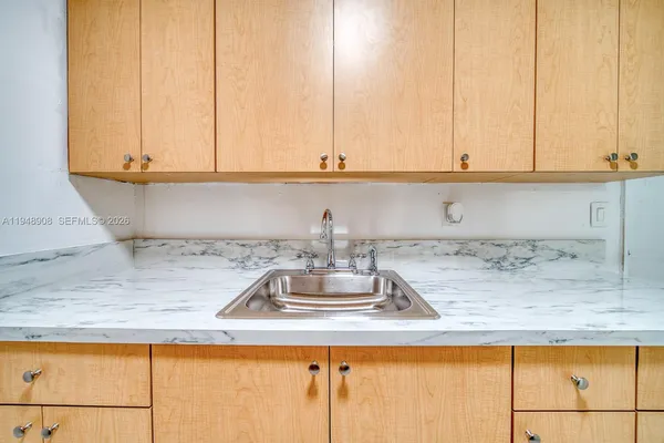a kitchen with a sink and cabinets