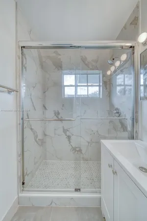 a bathroom with a bathtub and shower