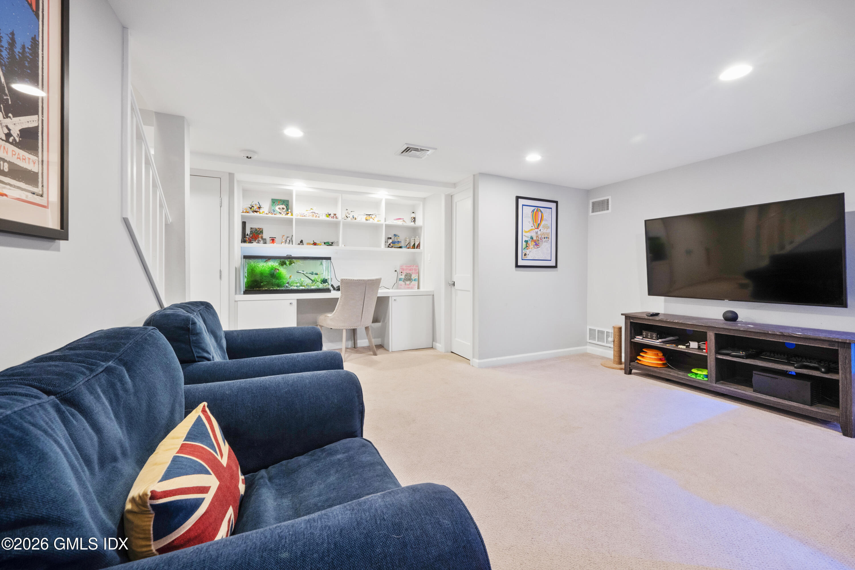 15 Pell Place Riverside, CT 06878 - Photo 28 of 35 a living room with furniture and a flat screen tv