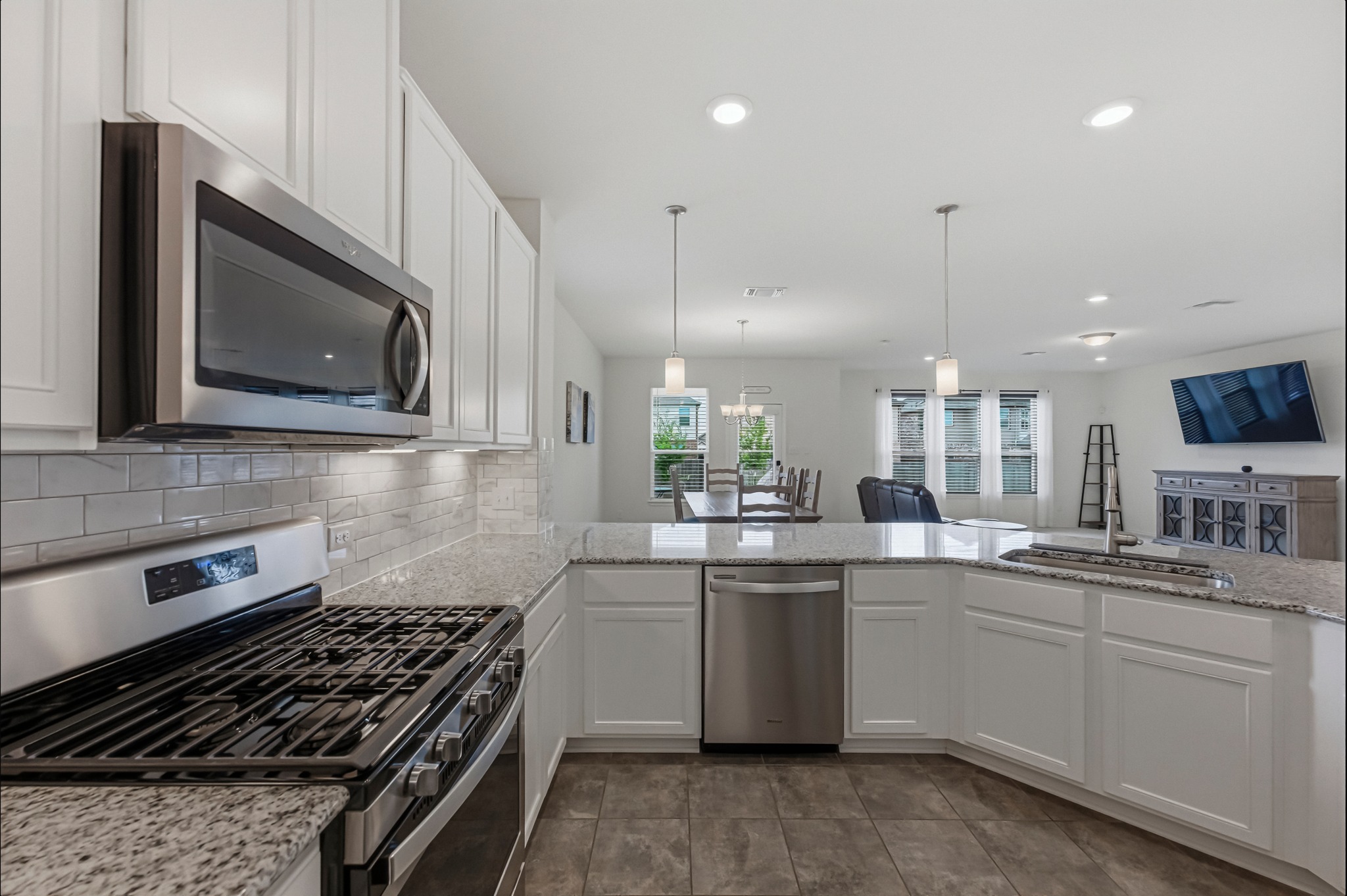1236 Cornith Lane Leander, TX 78641 - Photo 12 of 32 a kitchen with stainless steel appliances a sink stove and microwave
