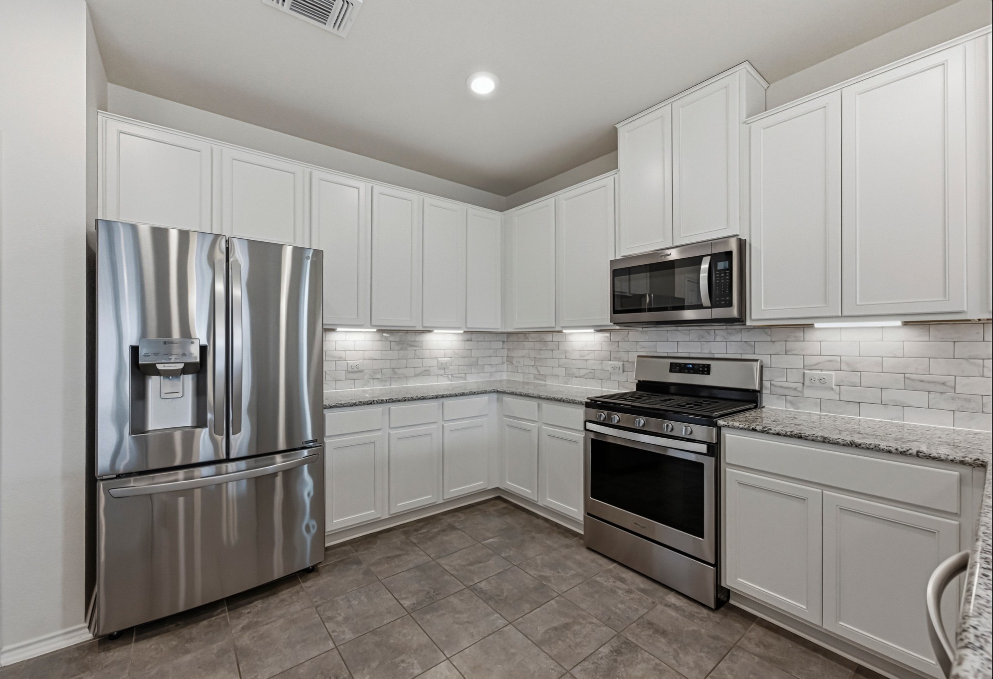 1236 Cornith Lane Leander, TX 78641 - Photo 13 of 32 a kitchen with stainless steel appliances granite countertop a refrigerator stove a sink and dishwasher