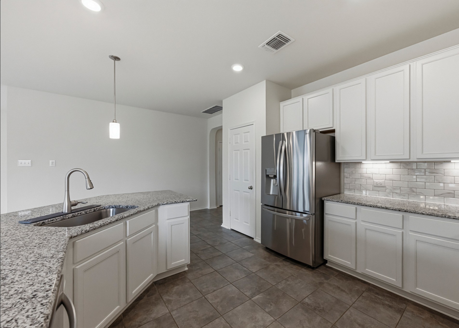 1236 Cornith Lane Leander, TX 78641 - Photo 14 of 32 a kitchen with stainless steel appliances granite countertop a sink refrigerator and microwave