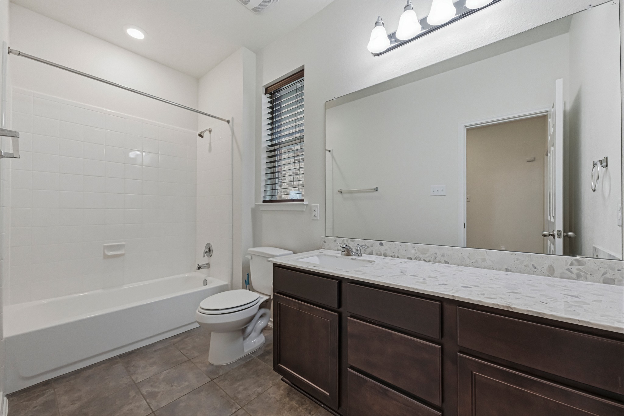 1236 Cornith Lane Leander, TX 78641 - Photo 26 of 32 a bathroom with a granite countertop sink a toilet and shower